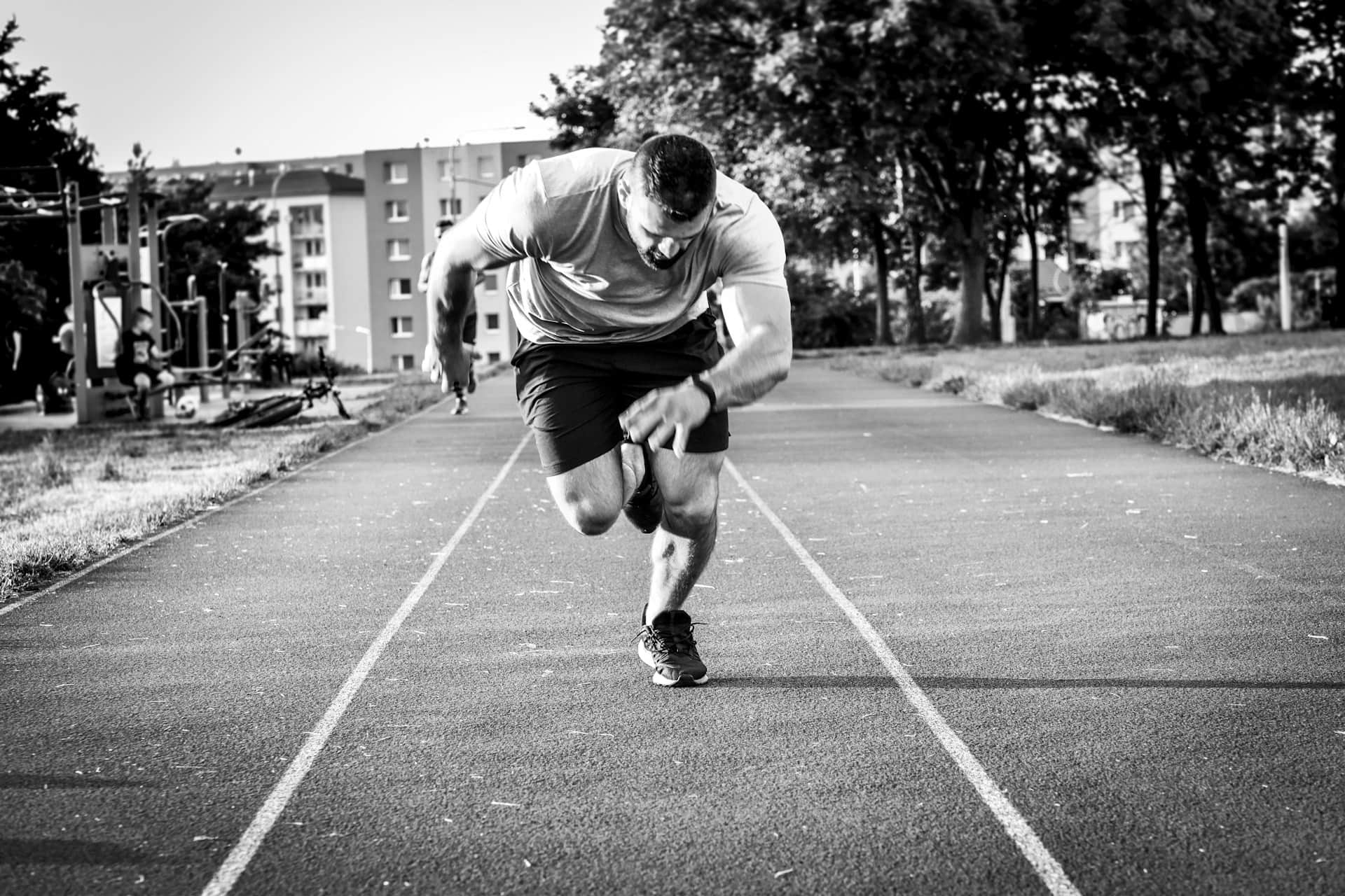 A black and white photo with a man running on a road, 3d perspective.This photo is related to sport physiotherapy motion recovery